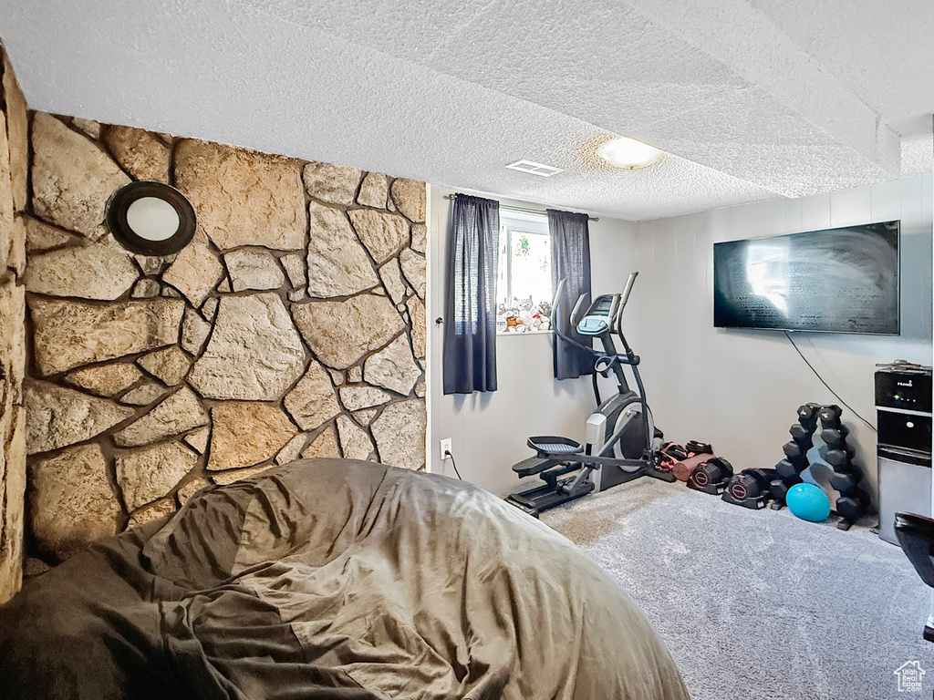 Bedroom featuring carpet floors and a textured ceiling