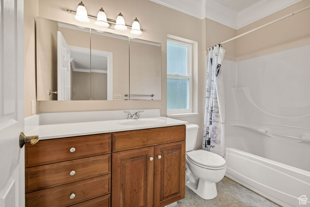 Full bath with vanity, crown molding, toilet, and shower / bath combination with curtain