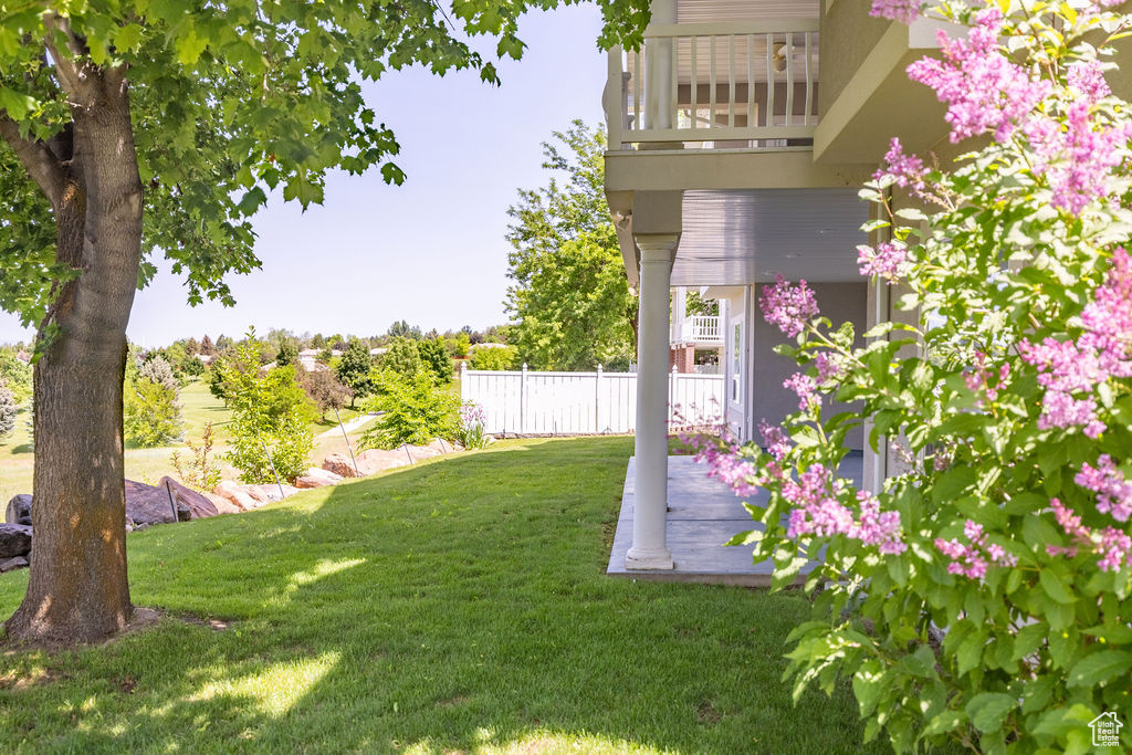View of yard featuring a balcony