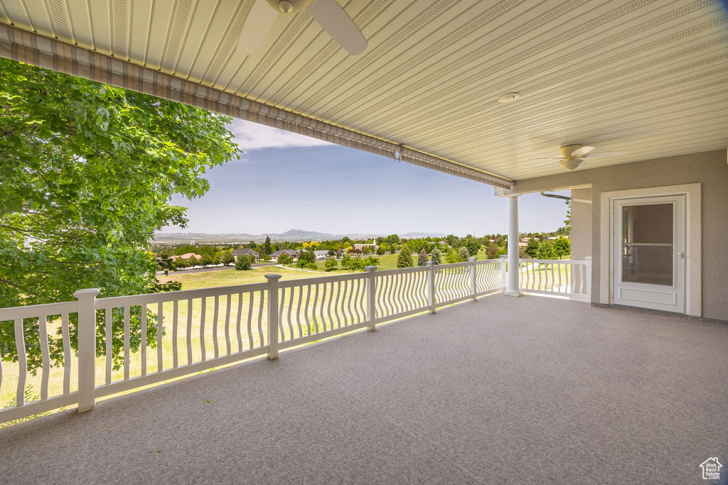 View of patio with a ceiling fan and a mountain view
