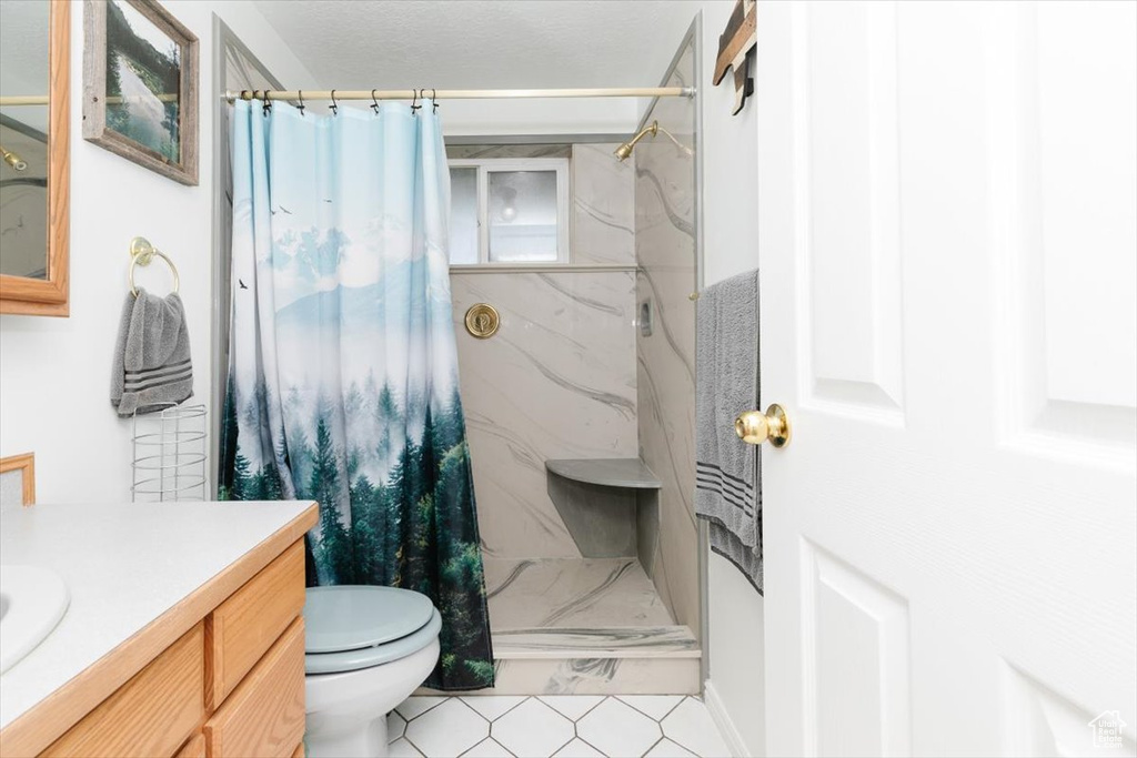 Bathroom featuring vanity, toilet, and a shower with curtain