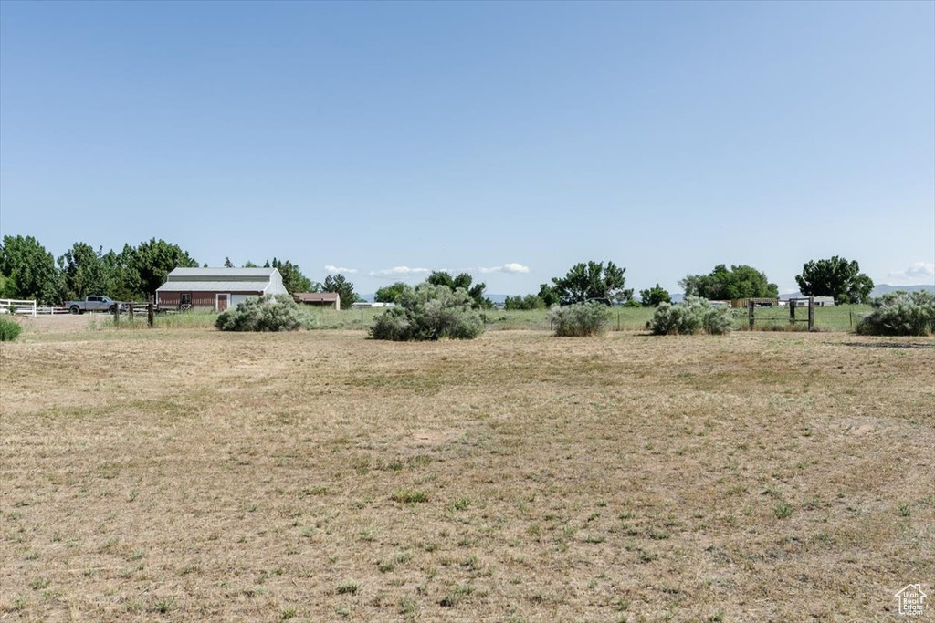 View of yard with a rural view
