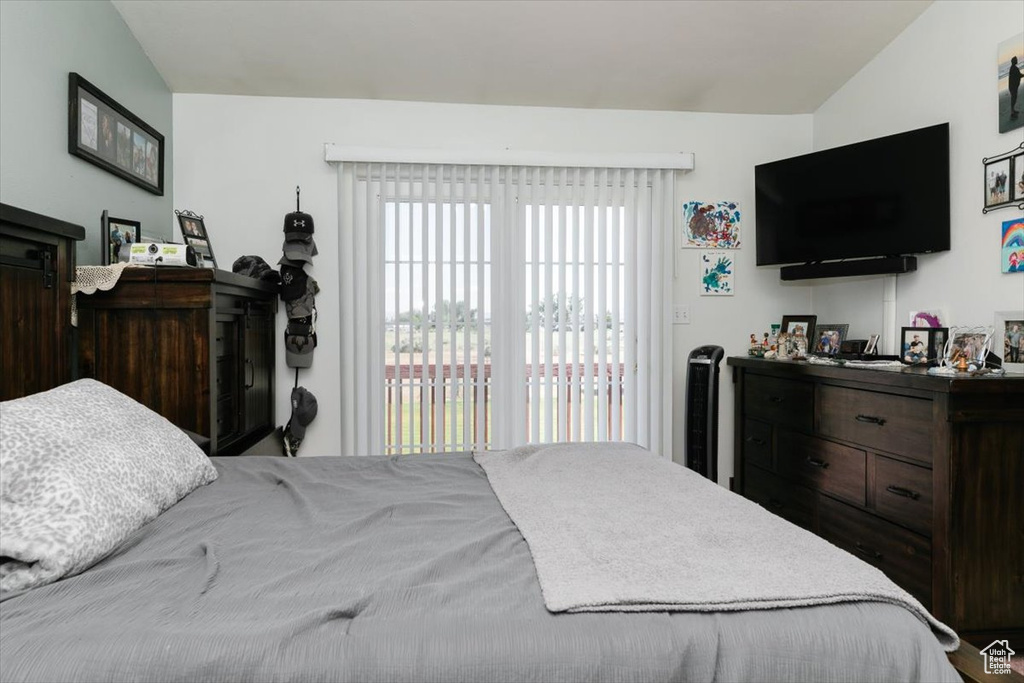 Bedroom featuring lofted ceiling