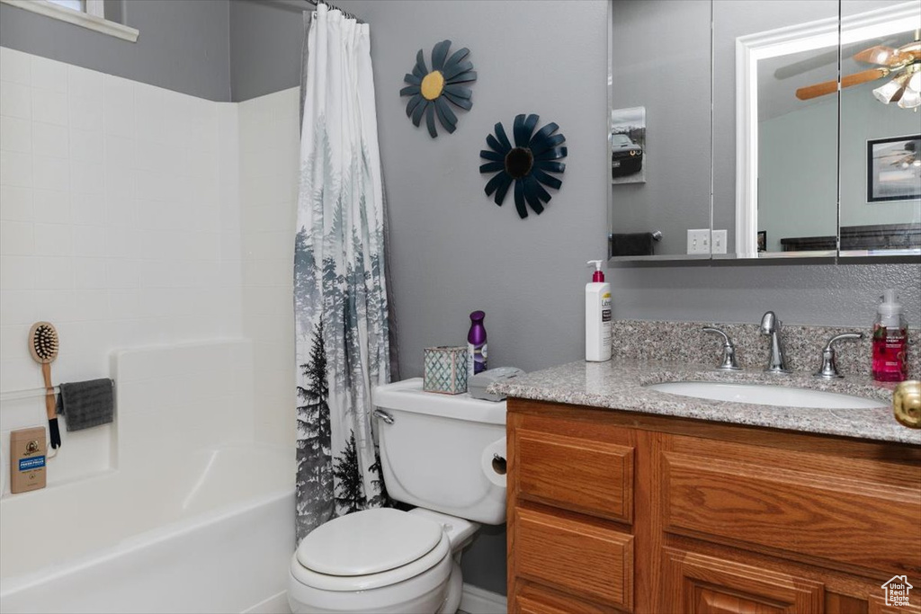 Full bath featuring vanity, toilet, and shower / tub combo with curtain