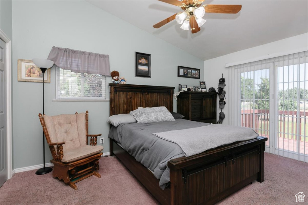 Bedroom featuring access to exterior, vaulted ceiling, light carpet, and ceiling fan