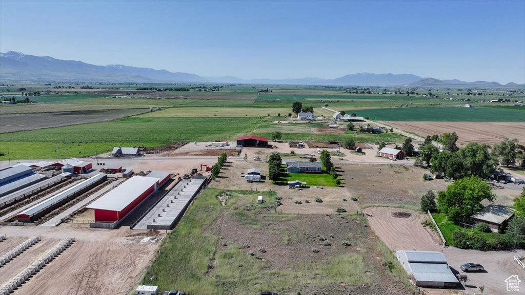 Aerial view of sparsely populated area with mountains and rows of crops