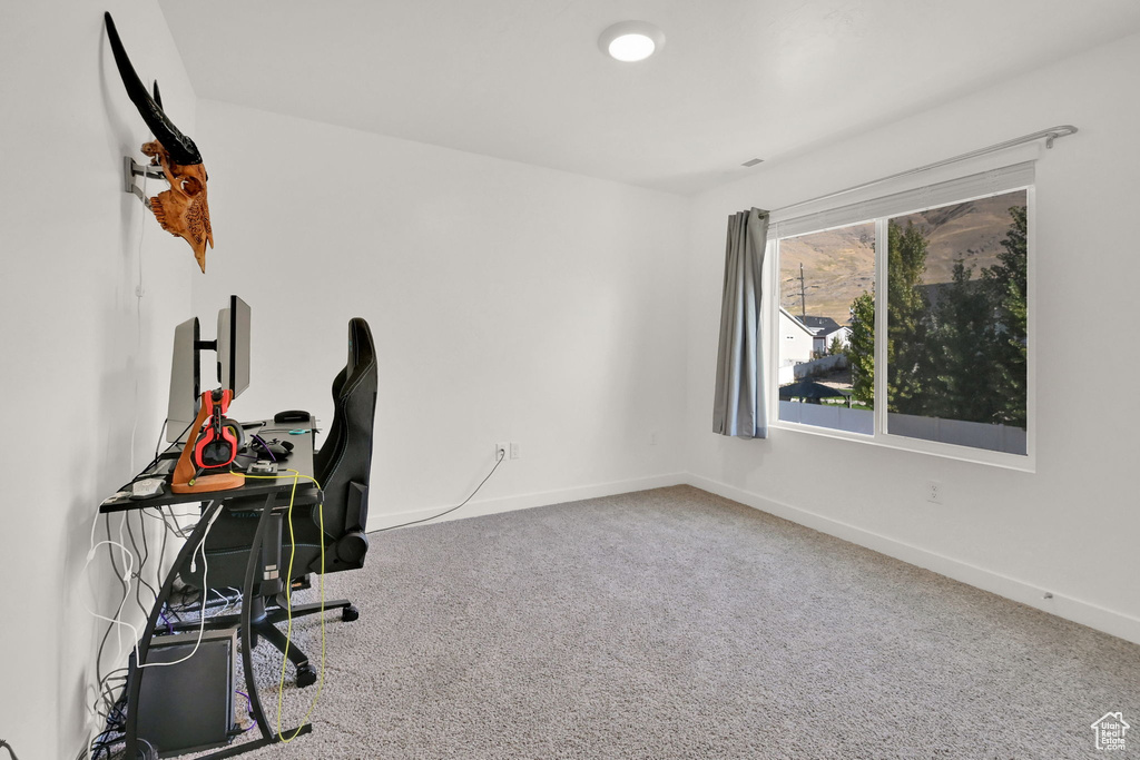 Unfurnished office with carpet floors and baseboards