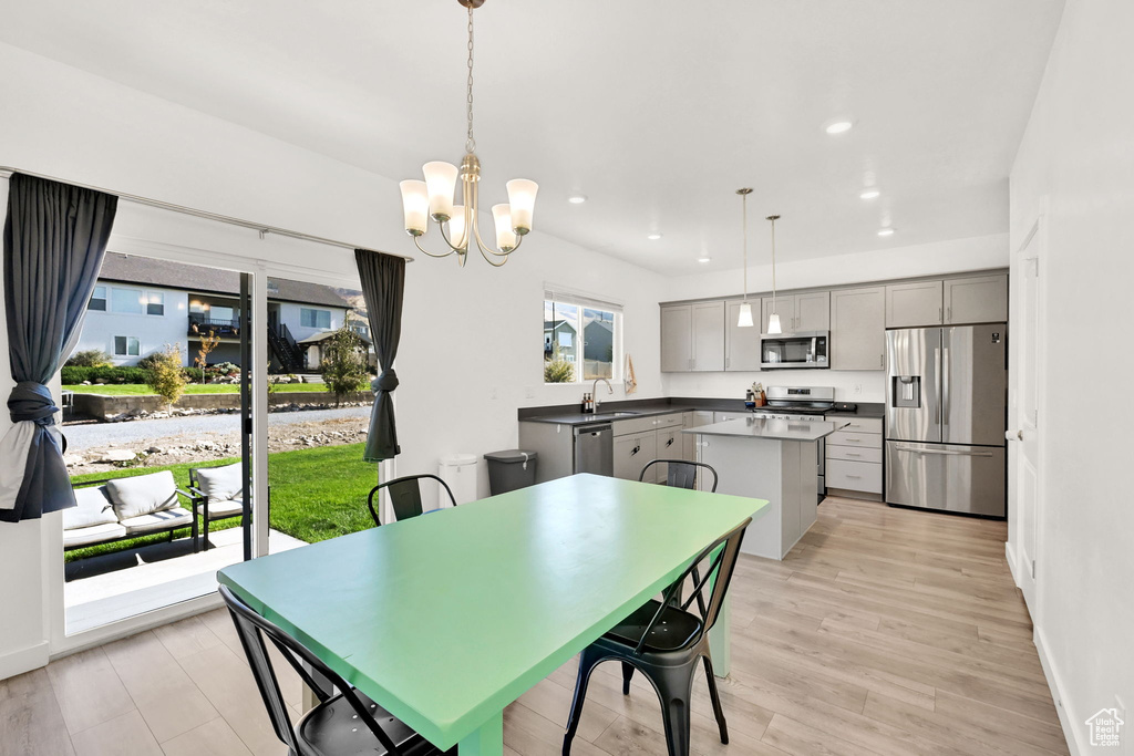 Dining room featuring light wood-style floors, recessed lighting, a chandelier, and baseboards