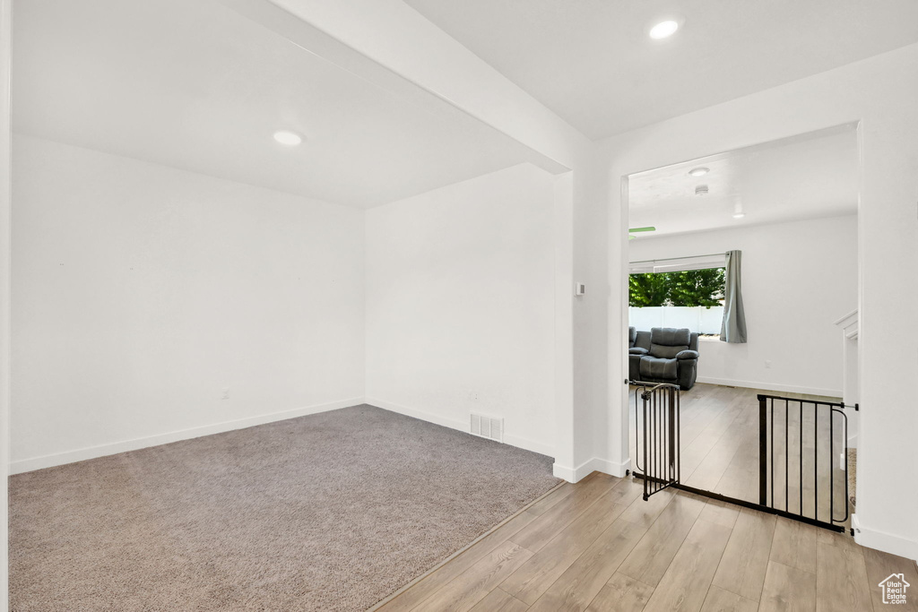 Unfurnished room with wood finished floors, recessed lighting, and baseboards