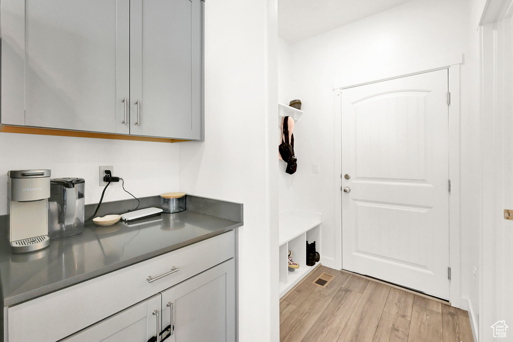Laundry area with light wood-type flooring