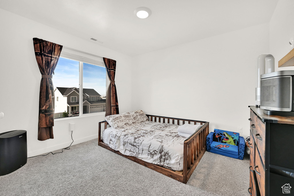 Bedroom featuring carpet flooring and baseboards