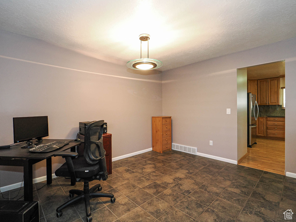 Office featuring baseboards and a textured ceiling