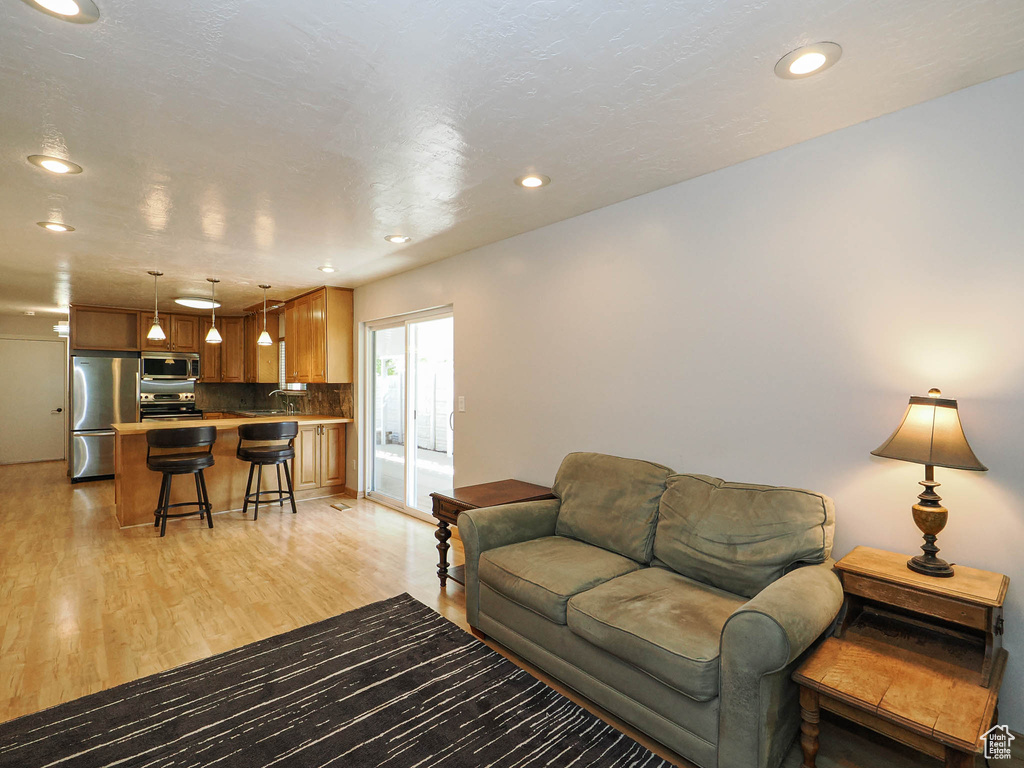 Living room featuring light wood finished floors and recessed lighting