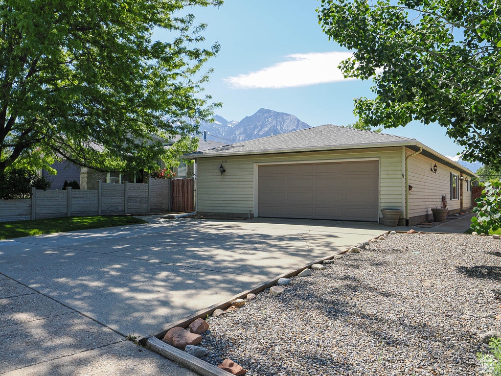 View of home\\\'s exterior with a garage, a mountain view, and driveway