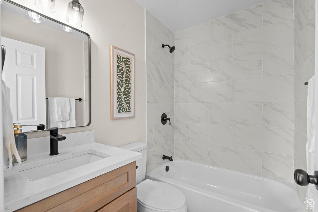 Bathroom with vanity, toilet, and shower / bathtub combination