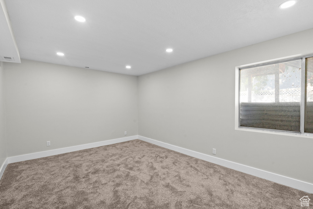 Spare room with carpet, recessed lighting, and baseboards