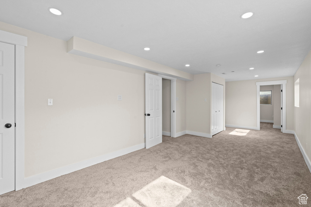 Carpeted spare room with recessed lighting and baseboards