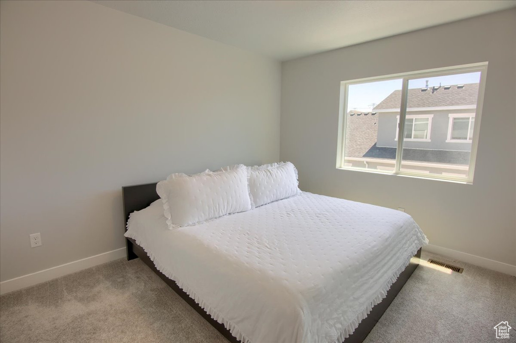 Carpeted bedroom with baseboards