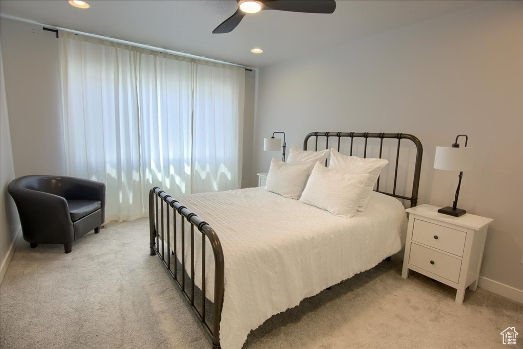 Bedroom featuring light colored carpet, recessed lighting, baseboards, and a ceiling fan