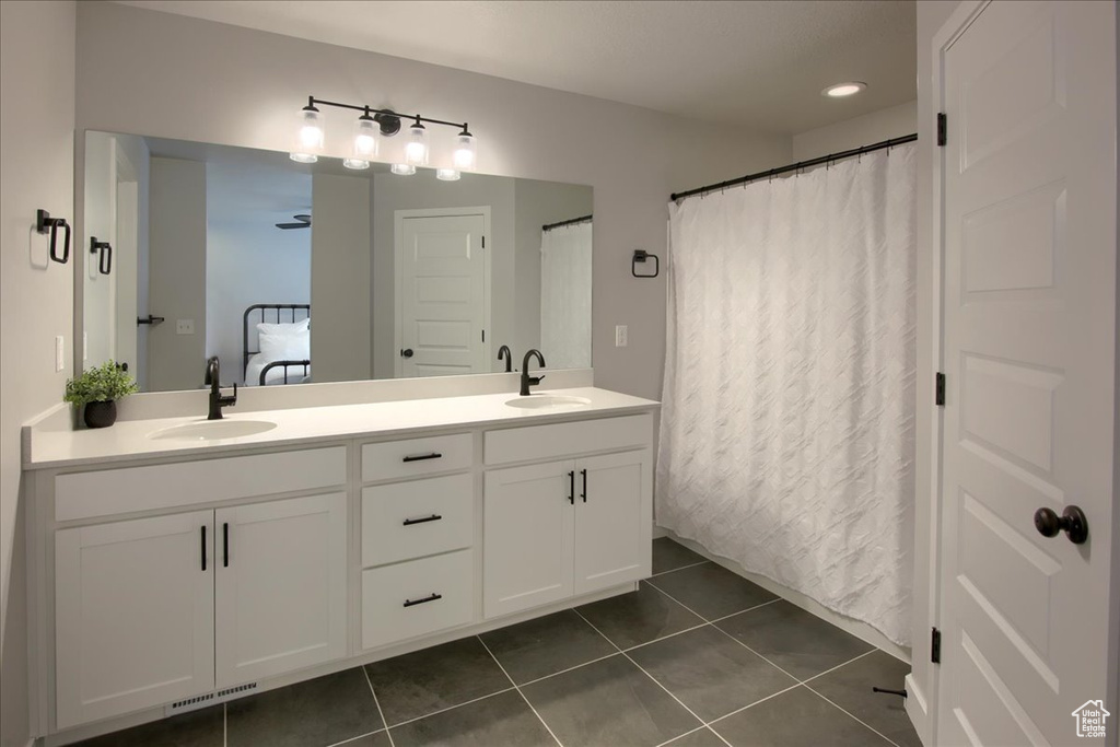 Bathroom with double vanity and tile patterned floors