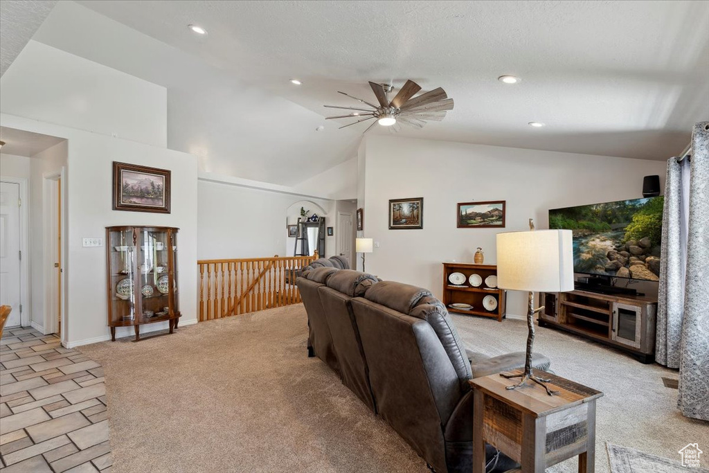 Living area featuring vaulted ceiling, light colored carpet, a ceiling fan, recessed lighting, and baseboards