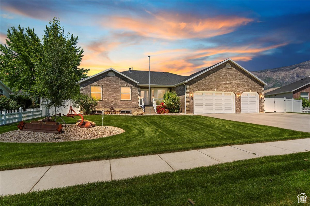 Single story home featuring a garage and driveway