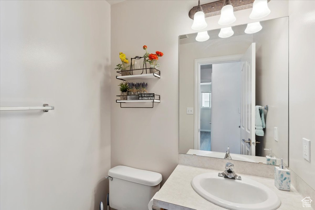 Half bathroom with toilet and vanity