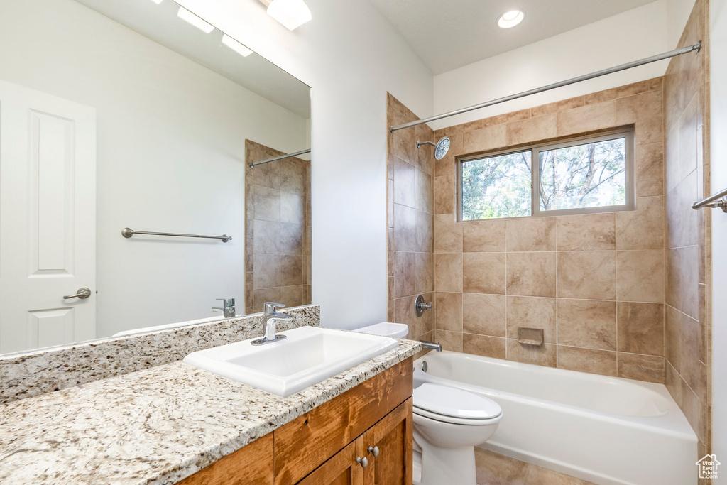 Bathroom featuring toilet, vanity, and bathing tub / shower combination