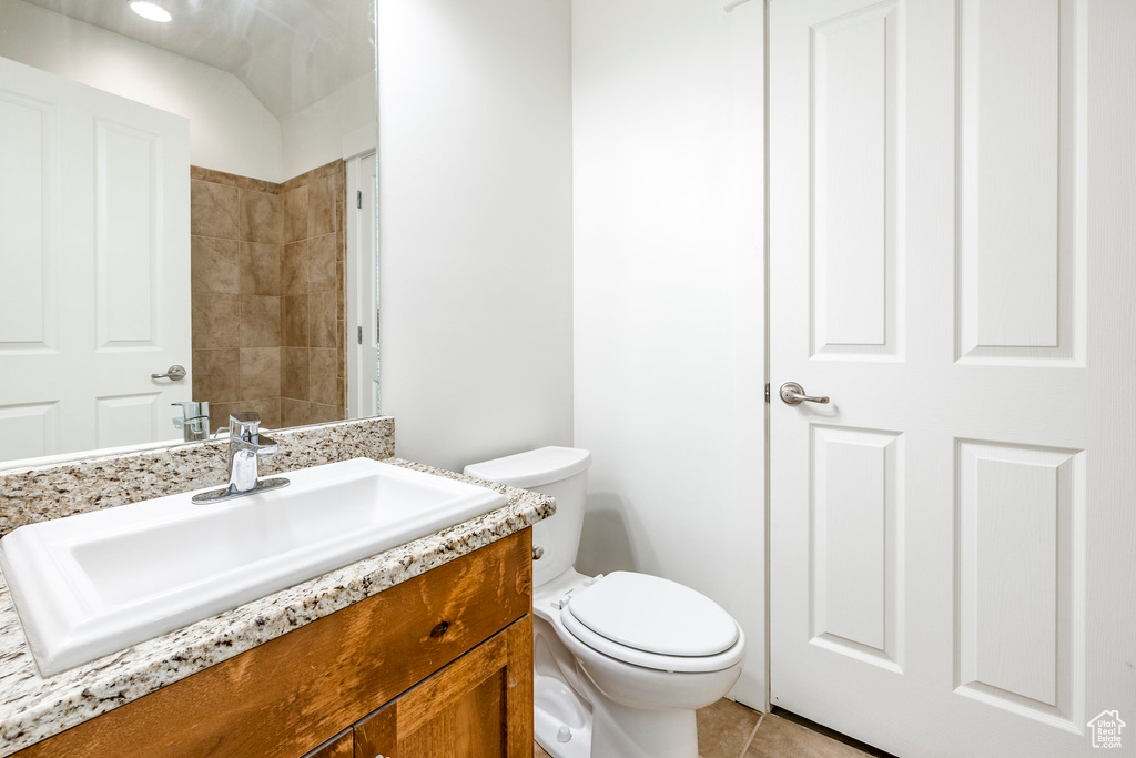 Bathroom featuring vanity, toilet, and tile patterned floors