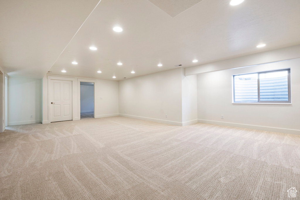 Spare room featuring light colored carpet, recessed lighting, and baseboards