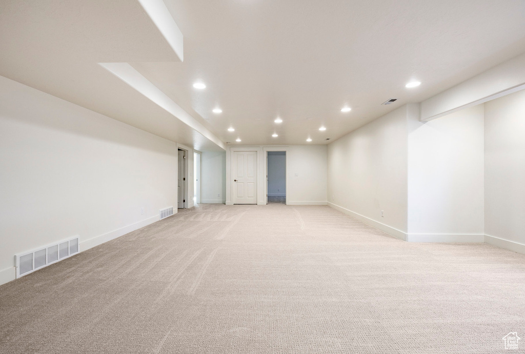 Empty room with recessed lighting, light colored carpet, and baseboards