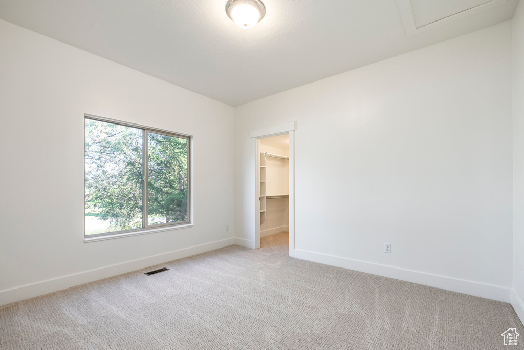 Empty room with baseboards and light carpet