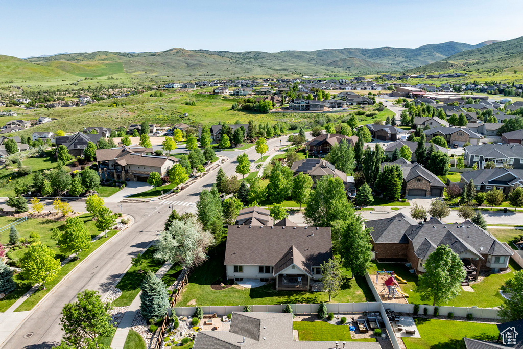 Aerial overview of property's location with nearby suburban area and mountains