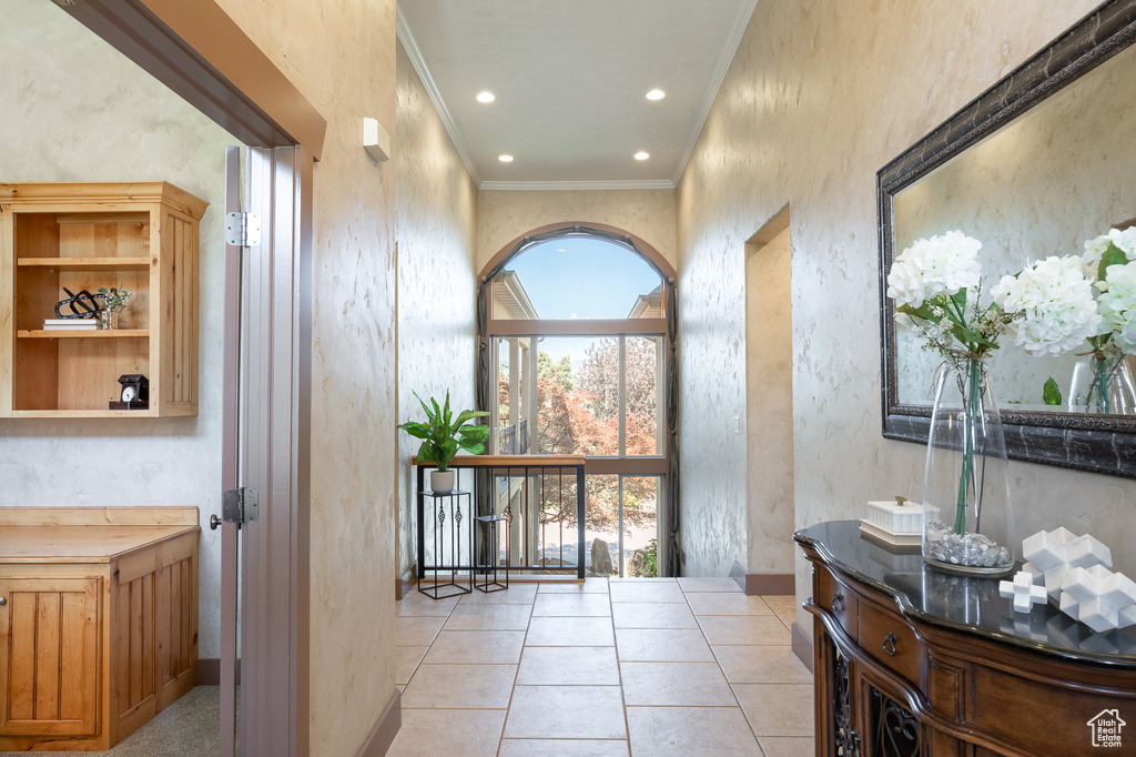 Foyer entrance featuring ornamental molding, recessed lighting, and light tile patterned floors