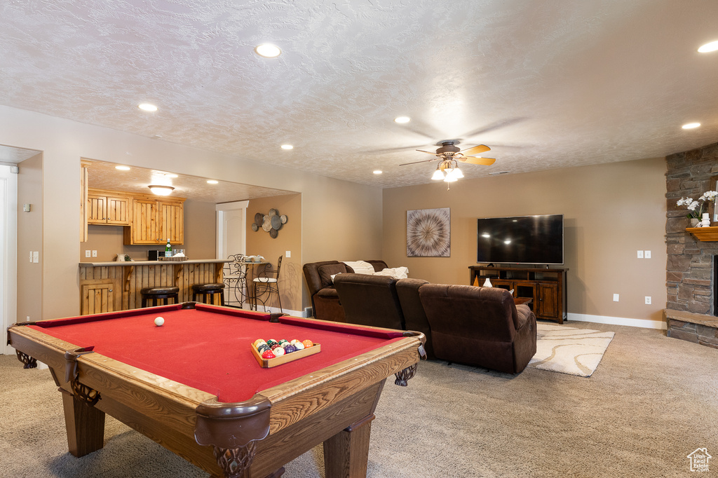 Game room with light colored carpet, recessed lighting, a fireplace, billiards, and a textured ceiling
