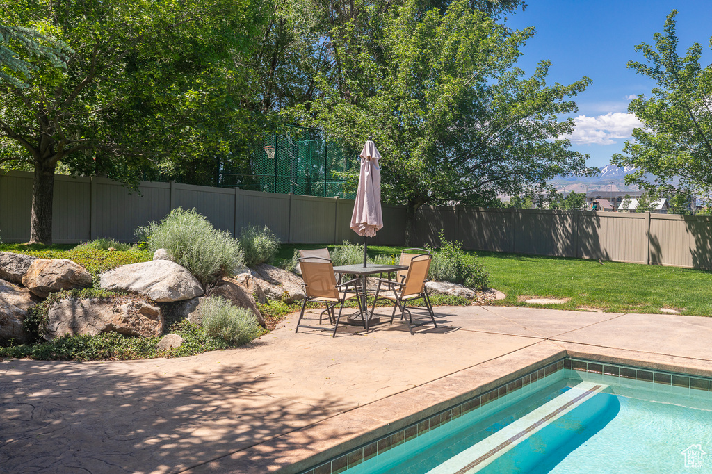 View of pool featuring a patio and outdoor dining space