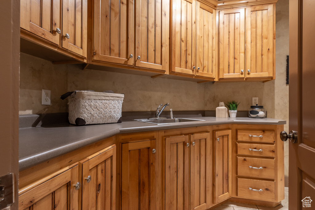Kitchen featuring a sink and brown cabinetry