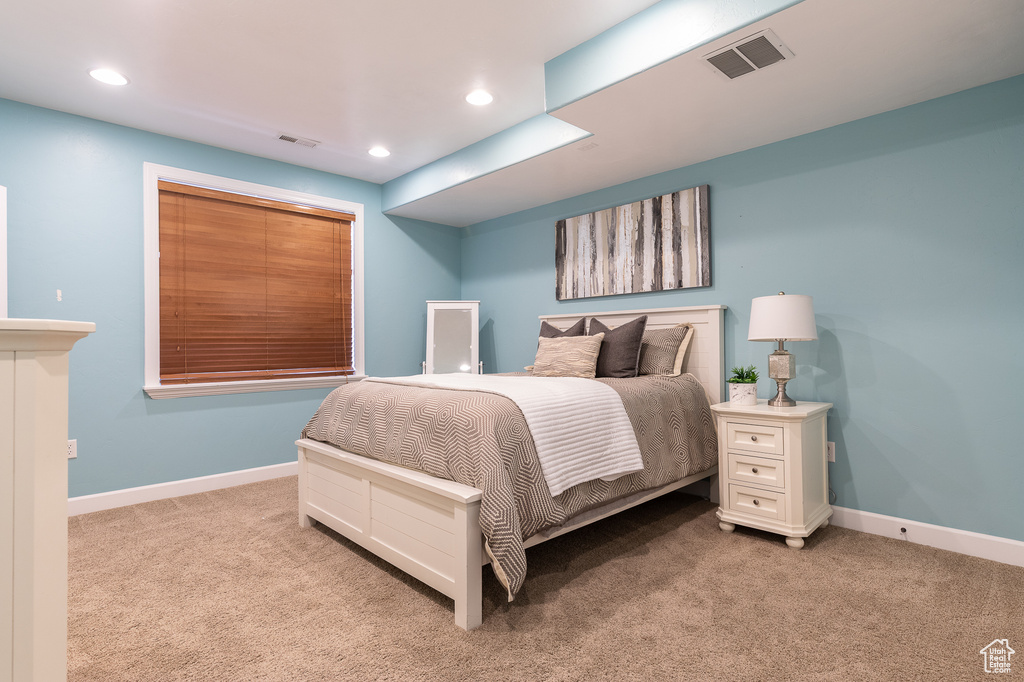 Bedroom featuring light colored carpet, baseboards, and recessed lighting