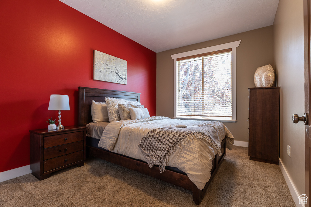 Carpeted bedroom featuring baseboards