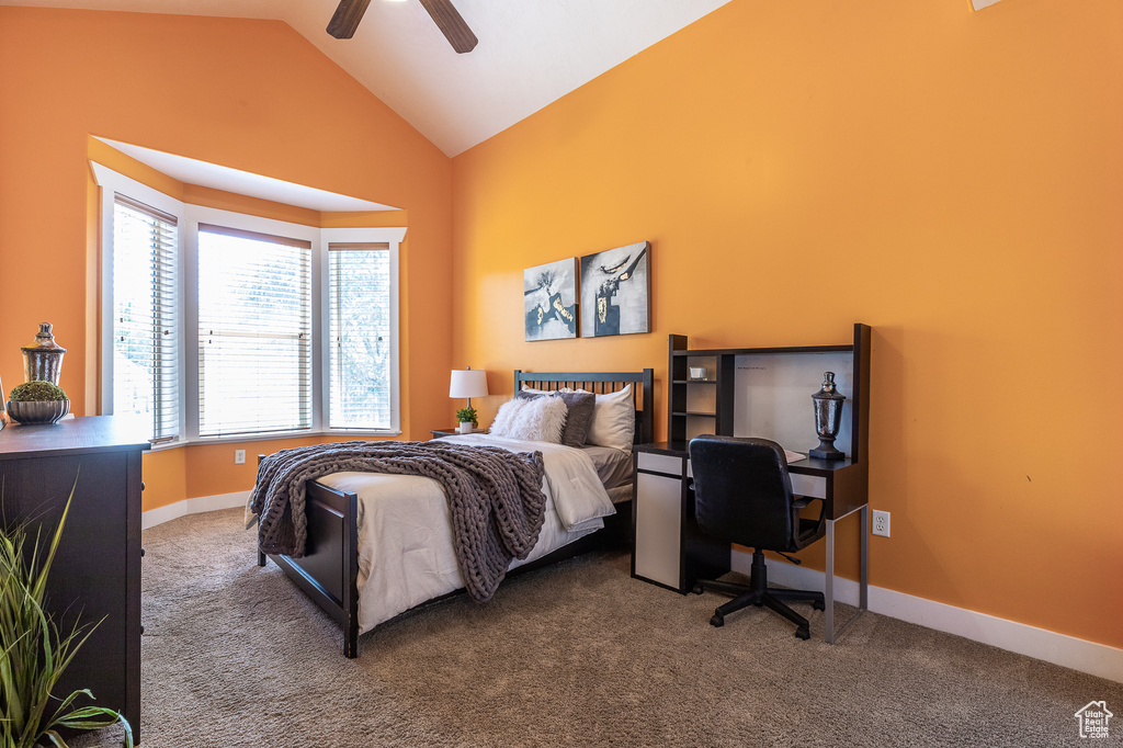 Bedroom featuring lofted ceiling, carpet, baseboards, and ceiling fan