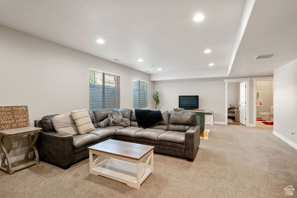 Living area featuring light carpet, recessed lighting, and baseboards