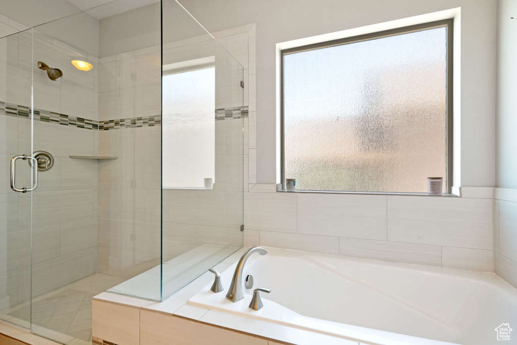 Full bathroom featuring a stall shower and a garden tub