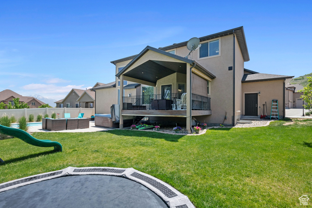 Rear view of property featuring an outdoor living space and stucco siding