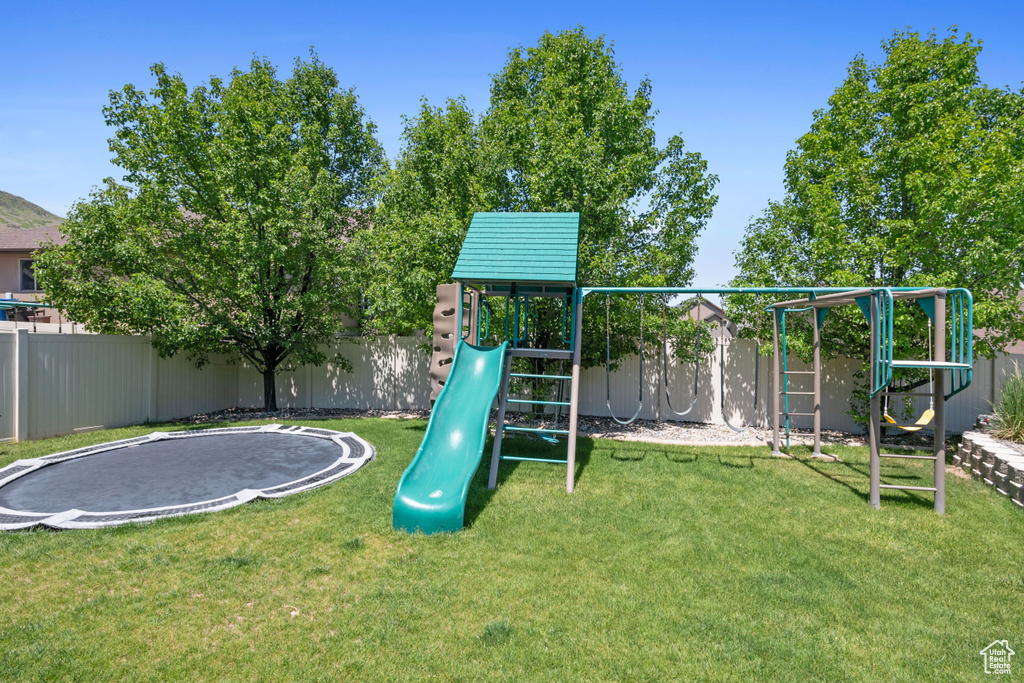 View of jungle gym featuring a trampoline
