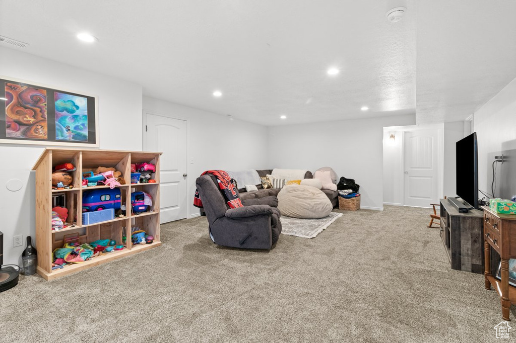 Carpeted living room with recessed lighting