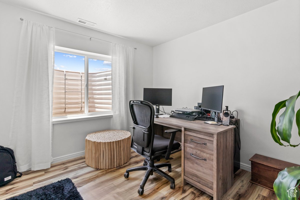 Home office featuring wood finished floors and baseboards
