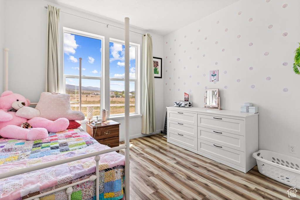 Bedroom with light wood-style flooring and baseboards