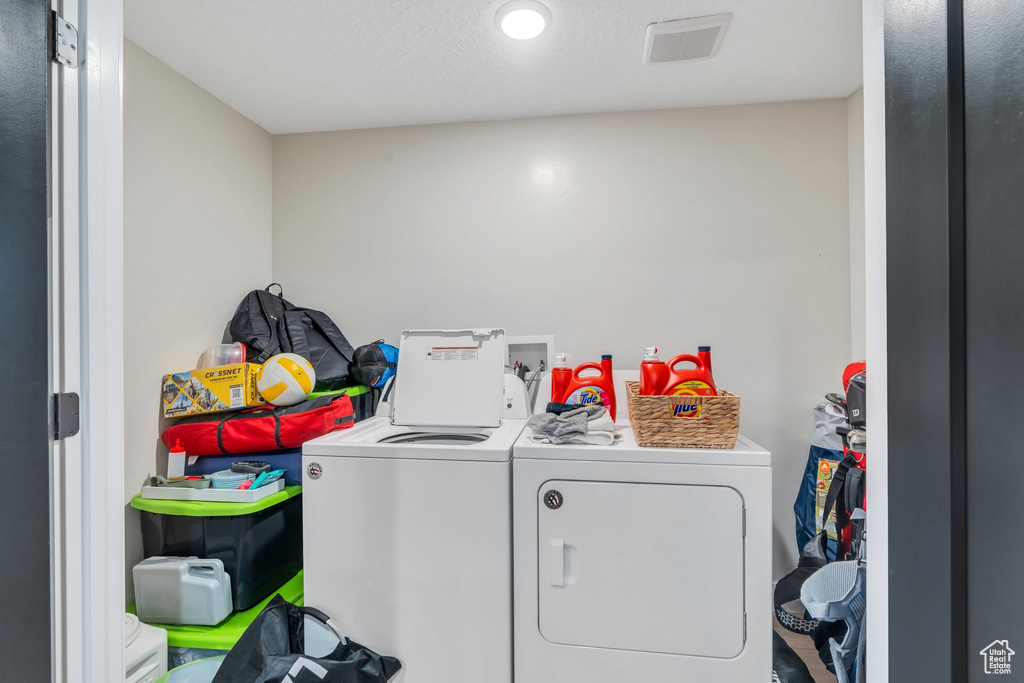 Laundry room featuring separate washer and dryer