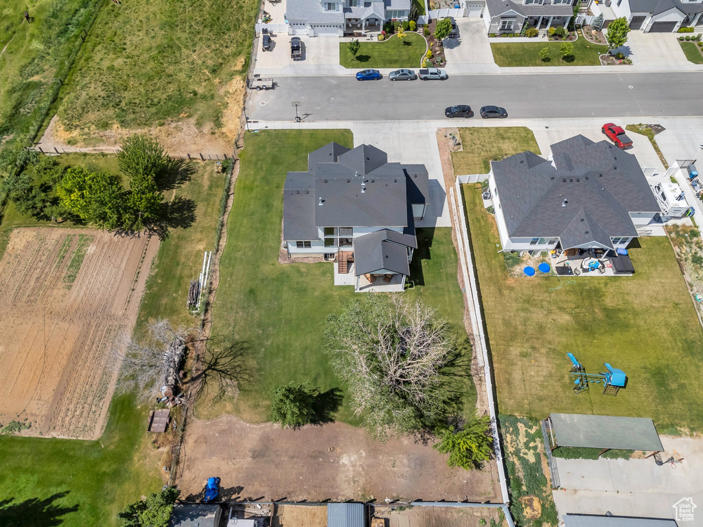 Aerial view of property and surrounding area with nearby suburban area