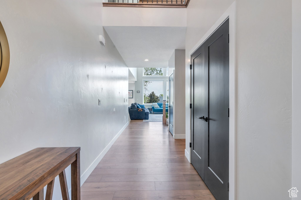 Hall featuring baseboards and wood finished floors